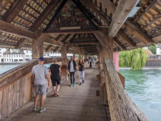 Spreuerbrücke in Lucerne. Not as old as Kapellbrücke, not as big, but to me, much more impressive, as it hasn't been completely rebuilt like its bigger sibling. Wooden truss bridge, with roof, with 17th century triangular paintings underneath the roof.

Overall, the bridges exemplify what I found unsettling about most historical buildings in Switzerland: they are refreshed/rebuilt/redone using very modern techniques, giving them that universal brand-new laser-sharp look. This bridge managed to avoid that (but the nearby bigger Kapellbrücke didn't, as it was rebuilt after almost completely burning down in 1993).