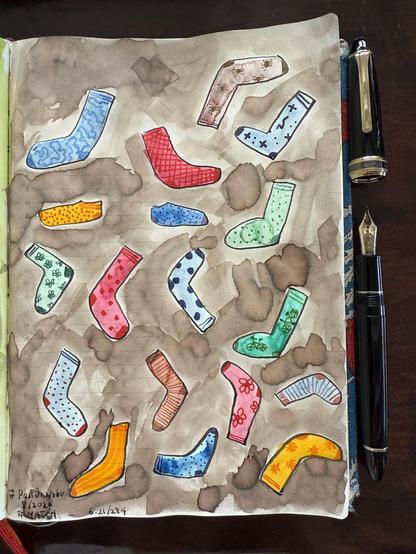 Sketch in sketchbook of all different socks in various colours and patterns.