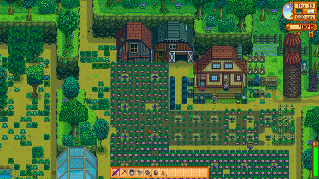 A screenshot from the video game Stardew Valley featuring a well-developed farm layout. The scene includes a farmhouse, barn, and coop surrounded by various crops arranged in tidy rows with sprinklers. Crafting machines and barrels are placed near the buildings. The farm is bordered by trees and pathways connecting different areas. The game interface shows it is Thursday, the 18th, at 6:20 AM, and the player has 43,045 gold.