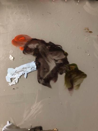 Paint marks on palette paper that inspired LEAPIN' LIZARD. The largest splotch is brown which eventually became the body, back legs, and tail. The adjacent red suggested the colorful head of the lizard. The white extending down on a diagonal is roughly claw shaped and became the fore limbs.