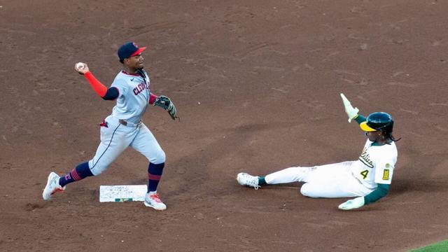 Cleveland Guardians outfielder Angel Martínez, left, turns a double play after getting Athletics' Lawrence Butler (4) out during the fifth inning of a baseball game Friday, June 20, 2025, in West Sacramento, Calif.