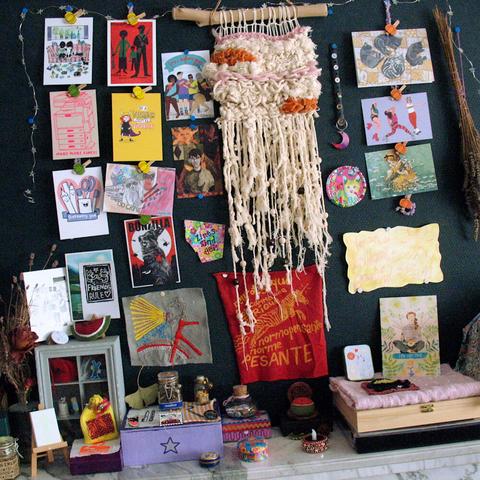 My entire Summer Solstice altar with postcards, spell jars, patches, giant woven wall art, and other artwork that expresses a summer vibe.