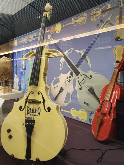 Yellow double bass of surreal shape and red cello