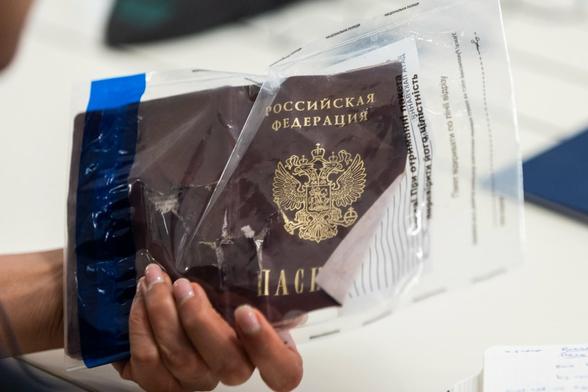 A dead russian terrorist with passport 
Putin offloading dead russian citizens, saying wrongly they are Ukrainians. 

Shows a dead orc passport.