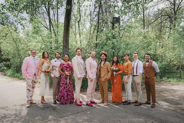 Two beautiful grooms and their wedding party posing on their wedding day at Schlitz Audubon Nature Center