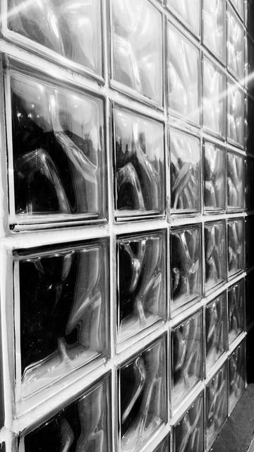 Looking at an angle across a wall made of thick, glass bricks