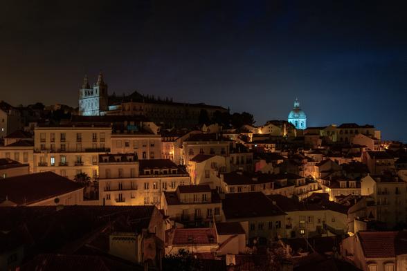 looking out from the Miradouro das Portas do Sol towards the Pantheon and the Sao Vicente monastery at 4:30 in the morning in Lisbon