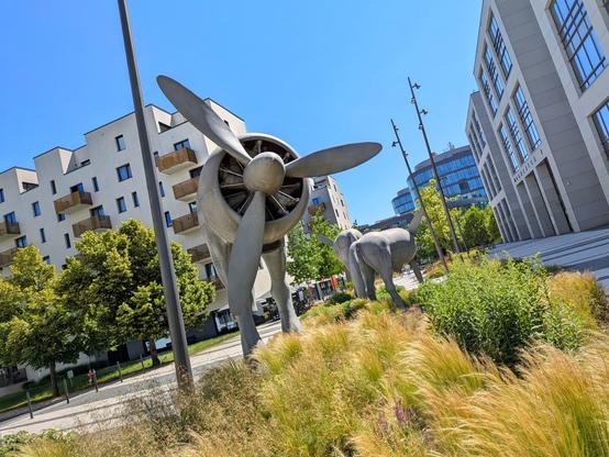 A sculpture of a cow with a jet engine in place of its upper body.