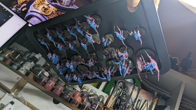 A lot of Tyranids on a metal plate upside down.