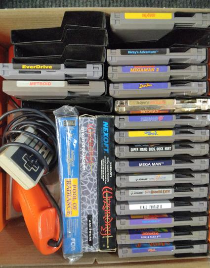 Box of assorted NES games and peripherals