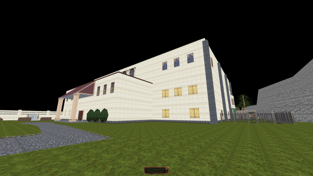 A fullbright screenshot of the dromed editor for Thief/Thief 2, showing a WIP mission. The screenshot shows a large manor with light textures, and the surrounding grounds. The front door of the manor and many windows are visible. A gated garden is visible on the right of the building.