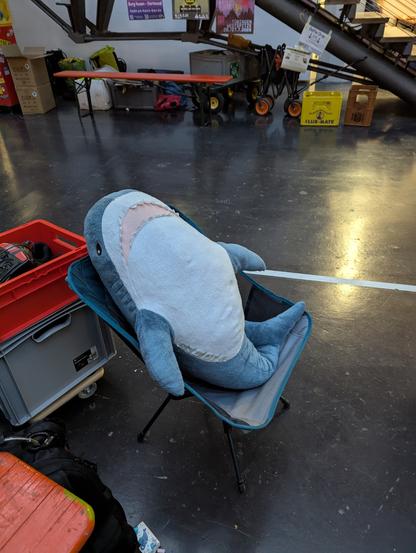 Blahaj sitting in fisherman's chair, watching pixelflut