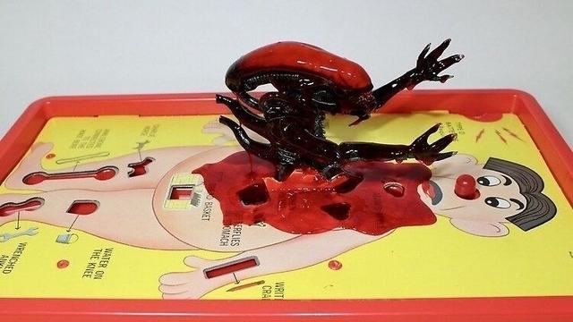 Xenomorph popping through the chest of the operation guy’s chest.