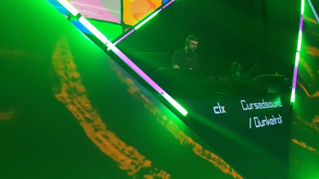 Orange green squares in the back, pink,white barlights and a red sphere in Front.