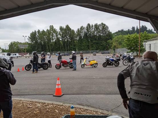 Photo by Neil E. Hodges in Evergreen Safety Council. May be an image of one or more people, people standing, motorcycle, scooter and road.