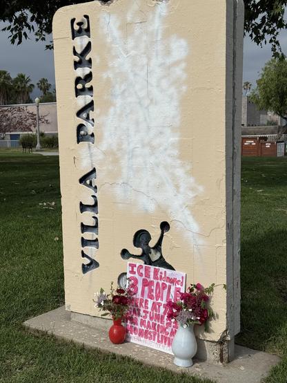 “Villa Parke” sign.

At its base are flowers and a sign that says, “ICE Kidnapped 3 People At 7 AM Sat June 21 For Making An Honest Living”

“Pasadena - Protect Our Neighbors”