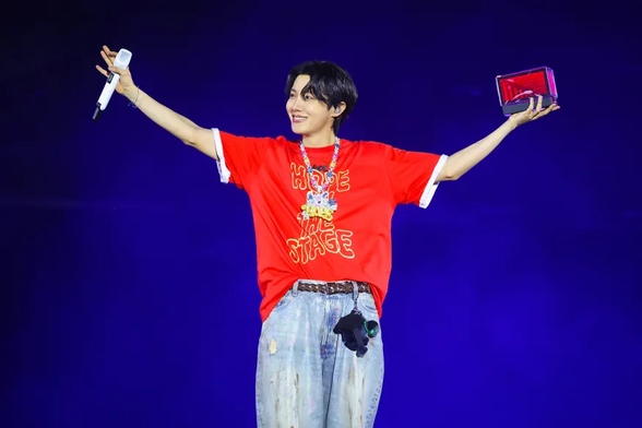 Hobi on the Stage in his red Hope on the Stage Tee, holding his little stage box.