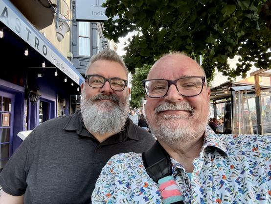 A selfie of me and my friend John on the sidewalk outside of the Castro Indian Restaurant