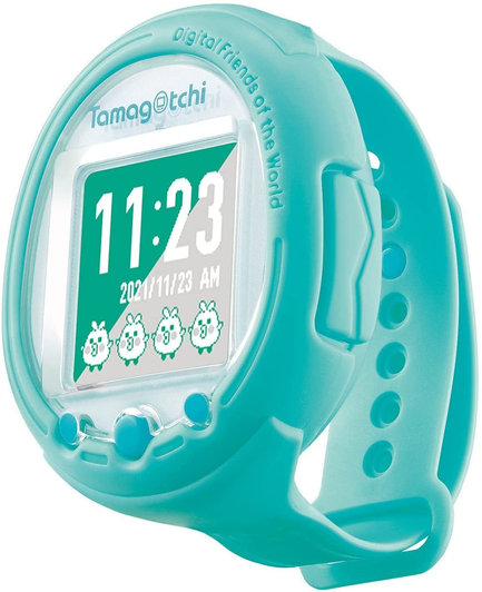 product photo of the "mint blue" tamagotchi smart watch. I think it looks more like seafoam green or a greenish cyan. It is a small tamagotchi with a wrist band that says "Digital Friends of the world". On the righ tyou can see a slot for plugging in tiny usb like smart card things. The time on the watch is 11:23 and you see a few cute chickens dancing on the screen.