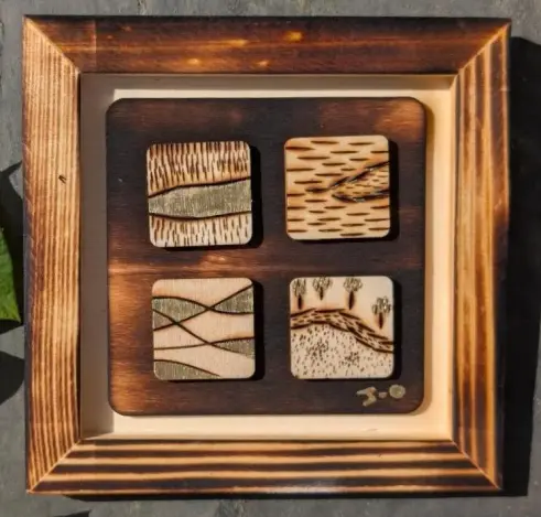 Tableau en pyroravure avec des petits chemins dessinnés