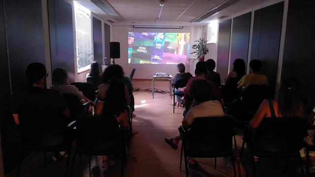 Sala de proyección a oscuras mientras la gente ve el capítulo 1 de Hope!