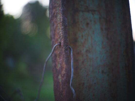 A rusty fence poll.