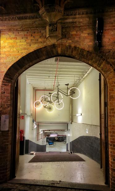 a bike garage with bike decorations hanging from the ceiling