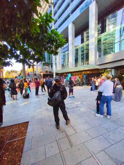 Passers by near the train station  entrance stop to listen to the music.