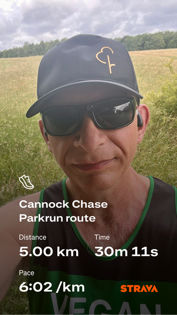 Strava screenshot with photo of me wearing a Parkrun hat, sunglasses and Vegan Runners vest, as background photo. Run details super imposed over photo: Cannock Chase Parkrun route; Distance 5km; Time 30m 11s; Pace 6:02/km