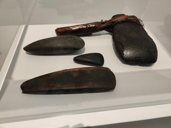 Three axe heads, early stone age, six to seven millennia old, and an axe head, before 1659.