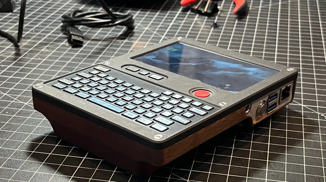 [ImageSource: Nicholas LaBonte]

On the inside is a Raspberry Pi and an RTL-SDR. The back of the unit is machined from hardwood, and sports a bronze heat sink for the Raspberry Pi. The front has a prominent red PSP joystick for mouse input and a custom keyboard.

On the right side is the power button and charging port, and astute readers may spot that the power button is where a double-stack of USB ports would normally be on a Raspberry Pi 5. [Nicholas] removed the physical connectors, saving some space and connecting the USB ports internally to the keyboard and SDR.