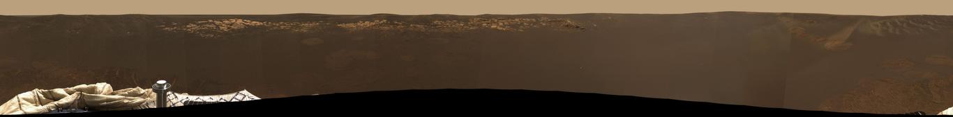 2004 February 4

Opportunity's Horizon
 * Credit: Mars Exploration Rover Mission, JPL, NASA

Explanation: 
Remarkably, the Opportunity Mars rover lies in a small martian impact crater about 3 meters deep and 22 meters wide. For 360 degrees, Opportunity's horizon stretches to the right in this new color mosaic image from the rover's panoramic camera. Notable in this view of the generally dark, smooth terrain are surface imprints left by the lander's airbags and an outcropping of light-colored, layered rock about 8 meters away toward the northwest. Though they look imposing, the rocks in the tantalizing outcrop are only a few centimeters high and will be dwarfed by the cart-sized rover itself during future close-up investigations. Opportunity has now rolled off its lander and, along with the restored Spirit rover, is directly exploring the martian surface. 

Authors & editors: Robert Nemiroff (MTU) & Jerry Bonnell (USRA)
NASA Web Site Statements, Warnings, and Disclaimers
NASA Official: Jay Norris. Specific rights apply.
A service of: LHEA at NASA / GSFC
& Michigan Tech. U.