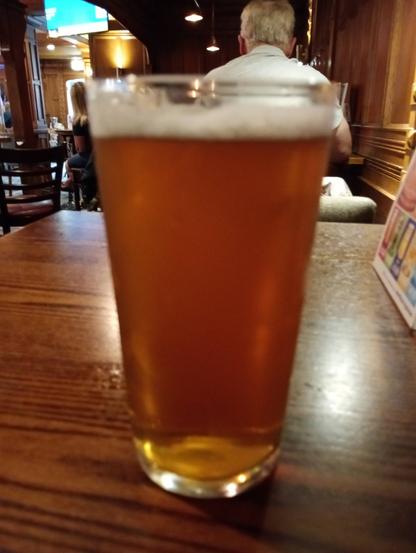 A pint of Peerless Brewing Citruvian Real ale on a pub table