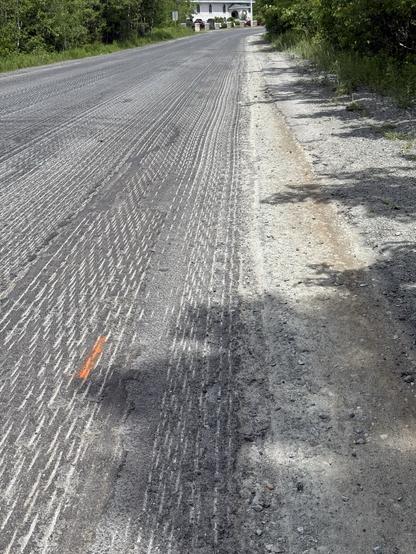 Road under construction, pavement ground down to washboard. But, they are adding paved shoulders.