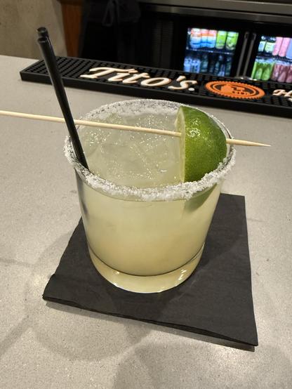 Margarita with a lime on a stick and salted rim