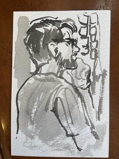 Postcard ink sketch of young man with dark hair and beard in profile with glasses