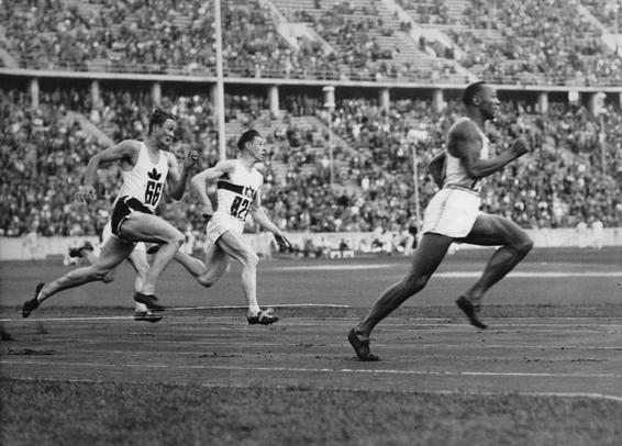 Jesse Owens running in the 200-meter sprint, for which he set an Olympic record, in Berlin, Germany, on 4 August 1936.