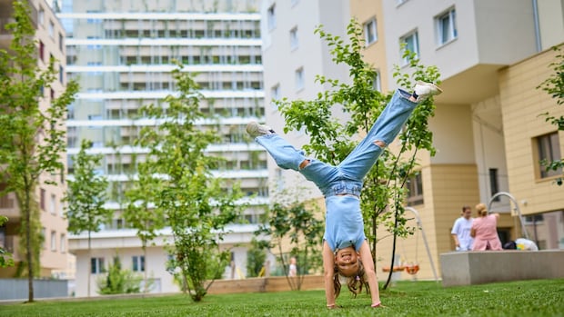 A girl does a cartwheel outside a social housing complex in Vienna. The Austrian city has become renowned among housing experts for its model of social housing, which provides heavily subsidized rental units to more than half of the city’s nearly two million residents.