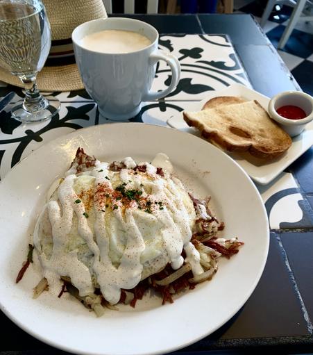 Breakfast - corned beef hash topped with two eggs, toast and strawberry jam, and a mug of cafe au lait - at La Provence Beaverton
