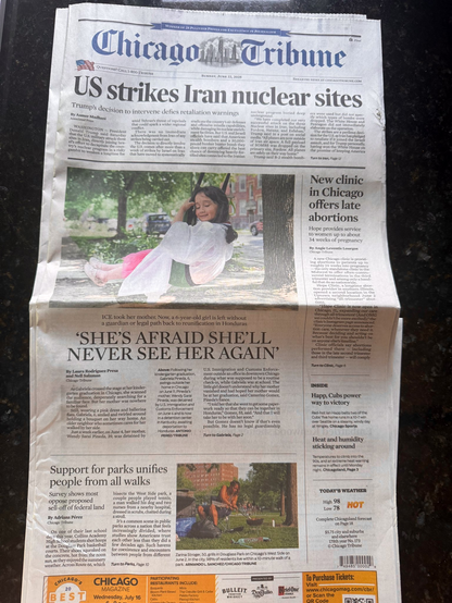 The front page of the Chicago Tribune, lead story on US strikes on Iran, & underneath, the on the little girl who has been left alone bc of the Trump regime's deportations: