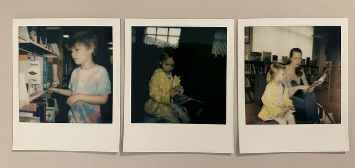 Three Polaroid photos show children reading and selecting books in a library setting.