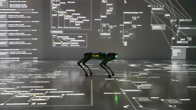 a robot dog standing in a projection of a vvvv patch.