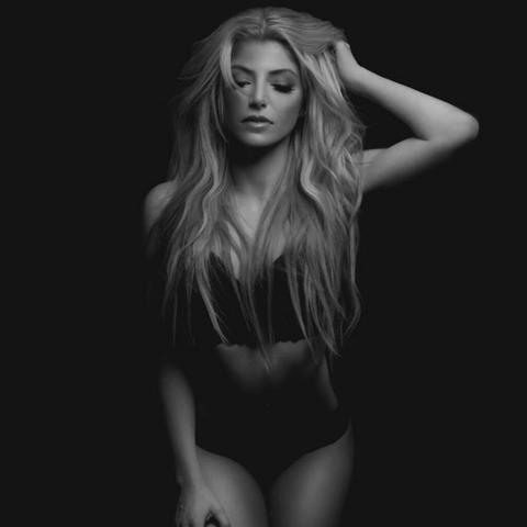 Me Brianne Howey poses in a black bralette black panties and black nylon stockings