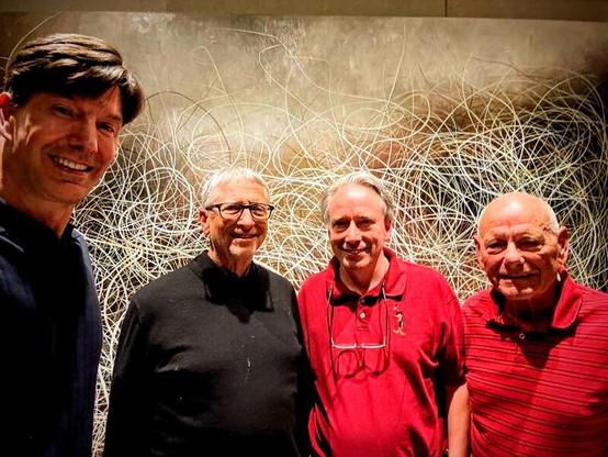 The image features four men standing side by side in front of a textured wall adorned with an abstract, white, scribble-like artwork. The man on the far left is wearing a dark blue shirt and has a warm smile. Next to him, the second man is dressed in a black sweater and glasses, with a neutral expression Bill Gates. The third man is wearing a red polo shirt with a small emblem on the left side and has a pair of glasses hanging from his shirt collar, smiling slightly Linus Torvalds. The fourth man, on the far right, is in a red striped polo shirt and is smiling broadly. The background artwork consists of numerous white lines crisscrossing against a muted brown backdrop, creating a dynamic visual effect.

 Ovis2-8B

🌱 Energy used: 0.157 Wh