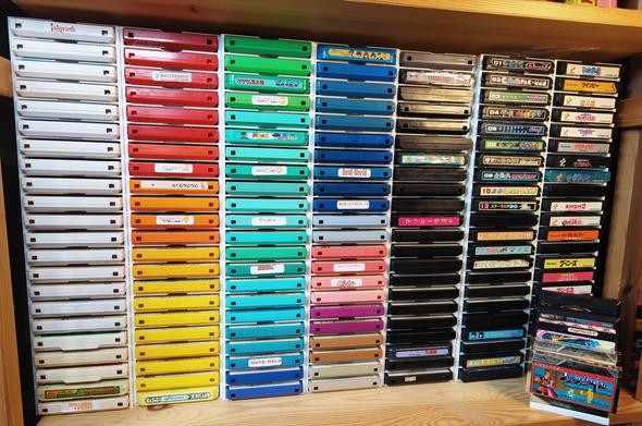 Stacks of famicom games somewhat sorted by rainbow order