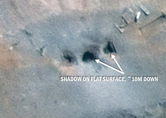 Close up of the most recent satellite image of the three holes, with arrows pointing to shadows on a flat surface inside of the holes.