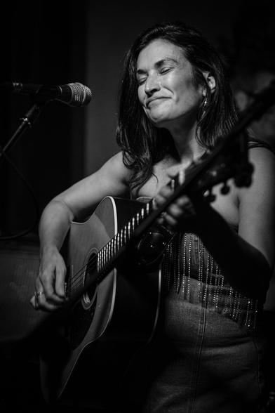Monochrome: Patti Rojas performing with her guitar