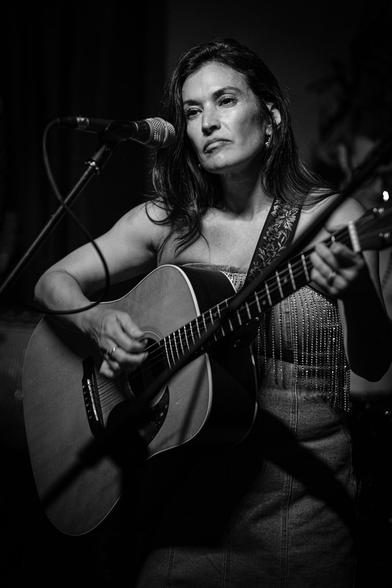 Monochrome: Patti Rojas performing with her guitar