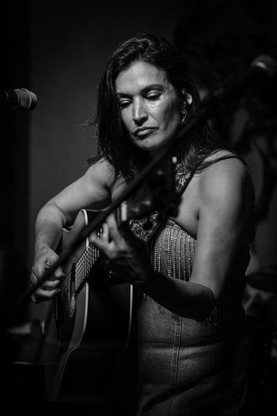 Monochrome: Patti Rojas performing with her guitar