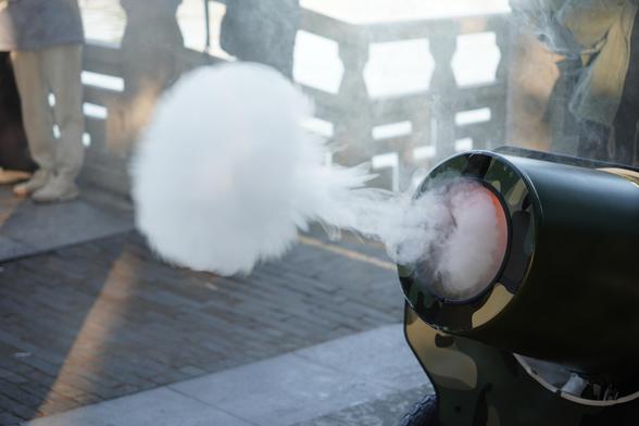 a cannon shooting out a puff of smoke. It is very foggy